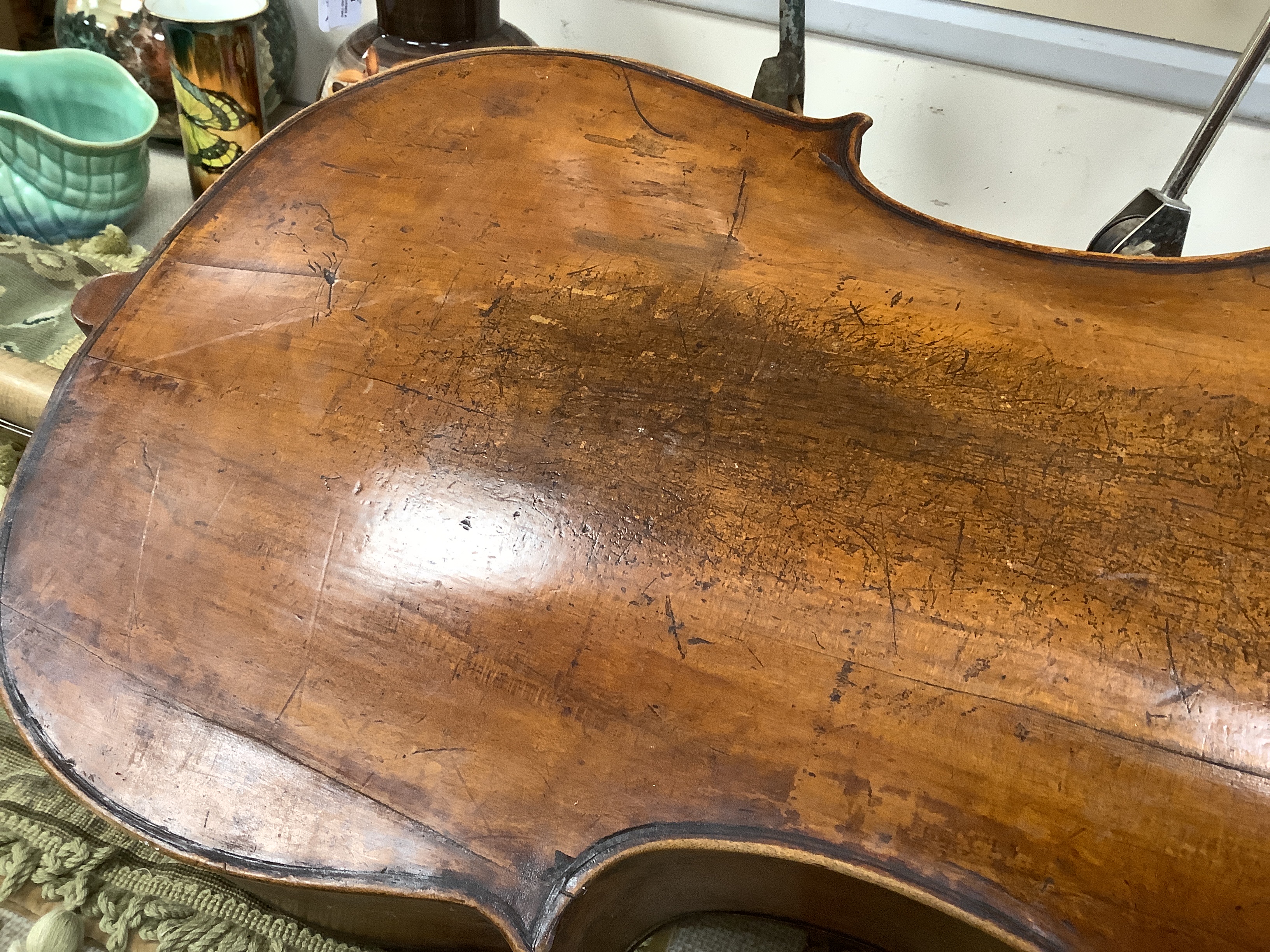 An early 20th century cello for restoration, indistinct internal label; ‘Restored by William J. Acton, Green Street, Forest Gate, London 1910’ length of body 72cm.